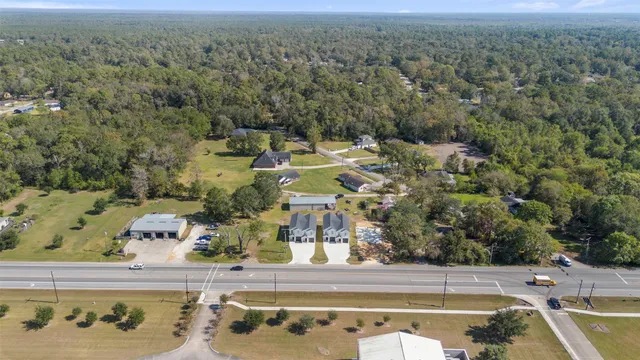 an aerial view of residential houses with outdoor space