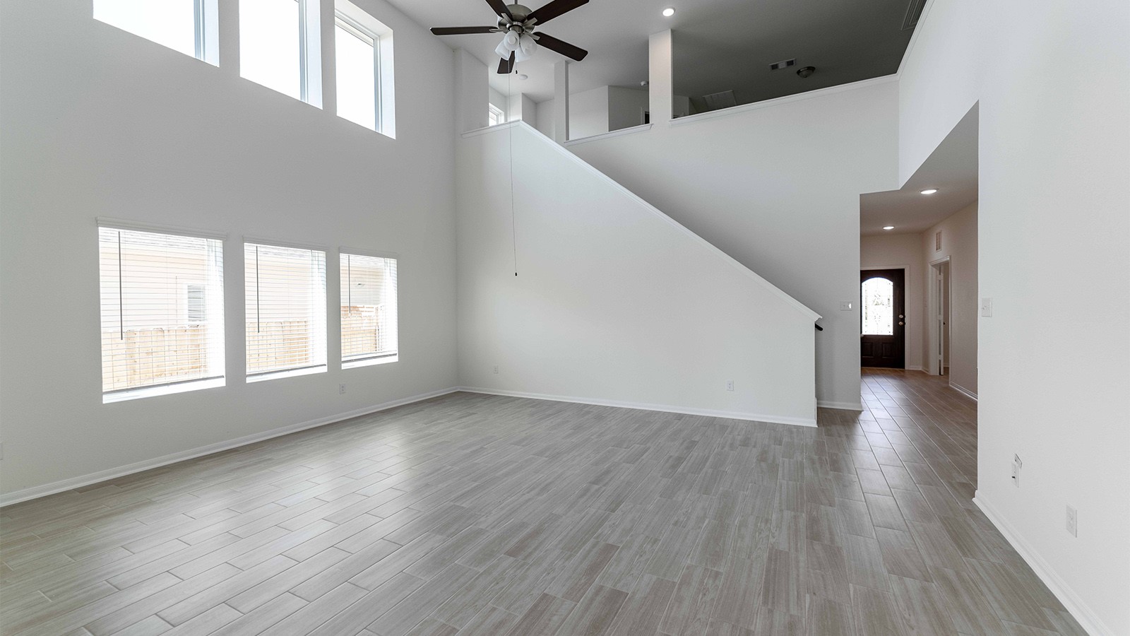 13621 Endless Narrow Lane Elgin, TX 78621 - Photo 2 of 19 a view of an empty room with wooden floor and a window