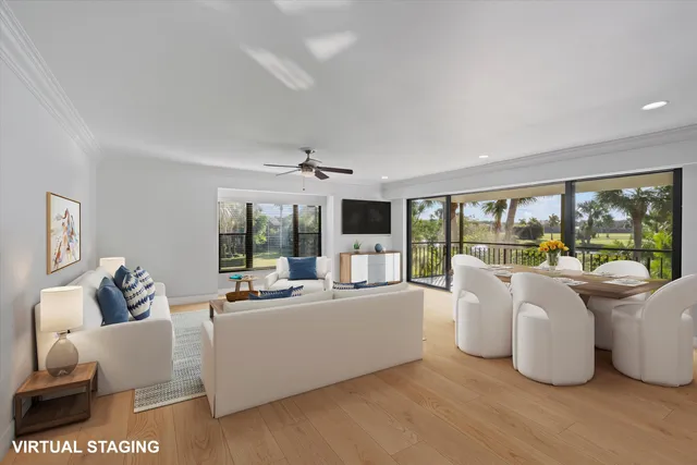 a living room with furniture and large windows