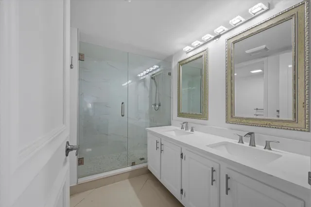 a bathroom with a double vanity sink mirror and double