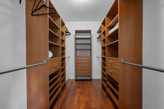 a view of walk in closet with empty racks