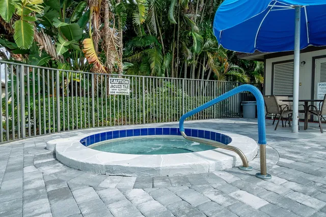 a view of a swimming pool with a patio and a garden