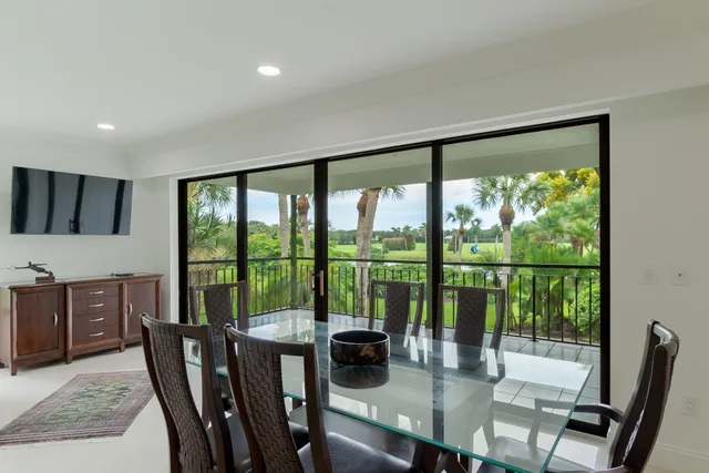a view of a large dining room with furniture window and wooden floor