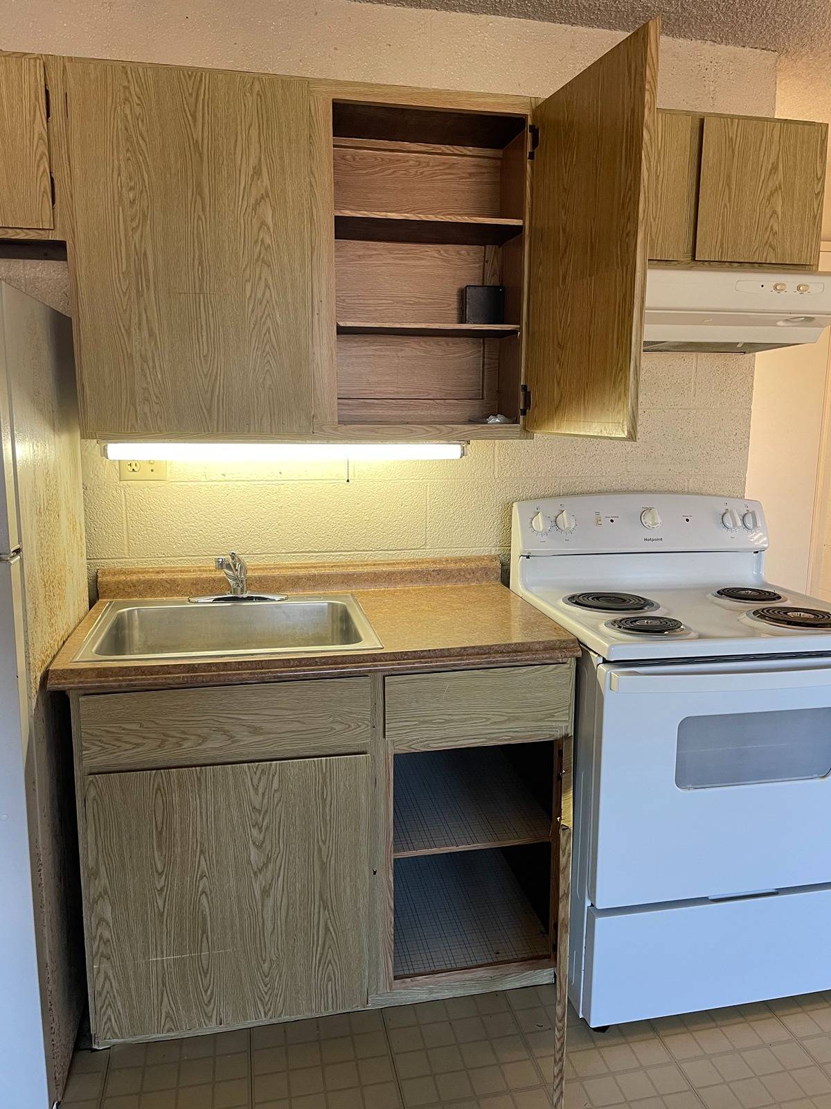 270 Ululani Street, Unit 22 Hilo, HI 96720 - Photo 9 of 13 a room with a sink cabinets and a window