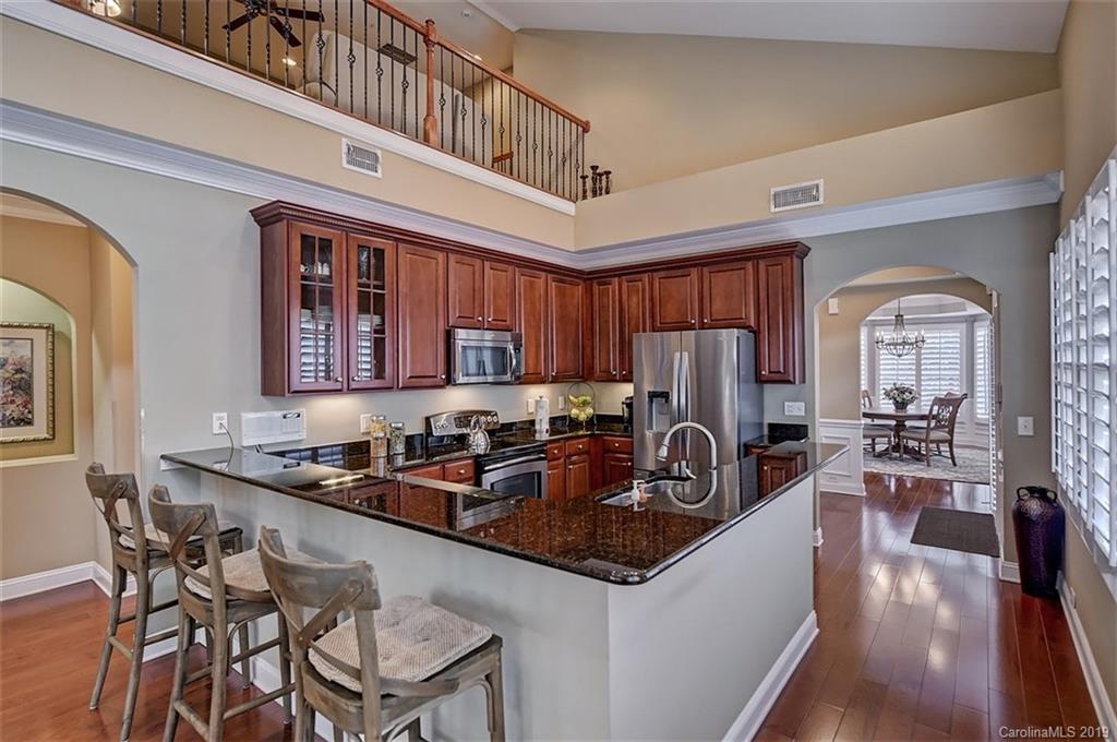 405 Halyard Lane Tega Cay, SC 29708 - Photo 11 of 48 a kitchen with sink a refrigerator and chairs