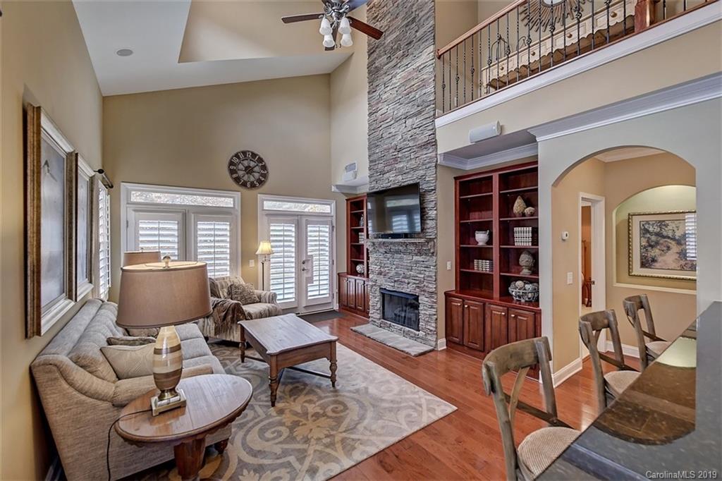 405 Halyard Lane Tega Cay, SC 29708 - Photo 16 of 48 a living room with furniture a fireplace and large windows