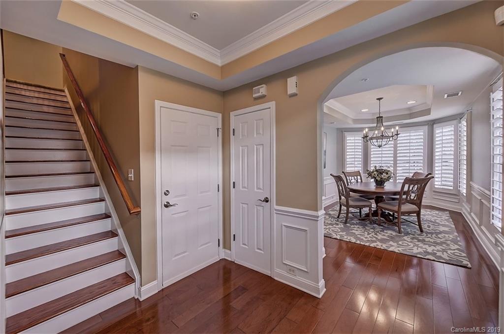 405 Halyard Lane Tega Cay, SC 29708 - Photo 3 of 48 a dining room with wooden floor and a hallway