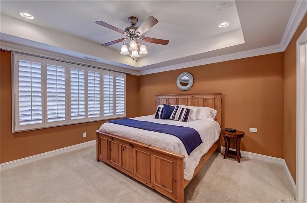 405 Halyard Lane Tega Cay, SC 29708 - Photo 23 of 48 a spacious bedroom with a bed and a chandelier