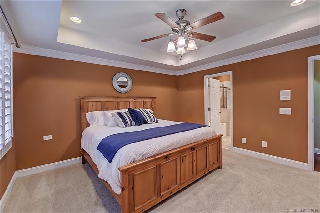405 Halyard Lane Tega Cay, SC 29708 - Photo 24 of 48 a bedroom with a bed and a chandelier
