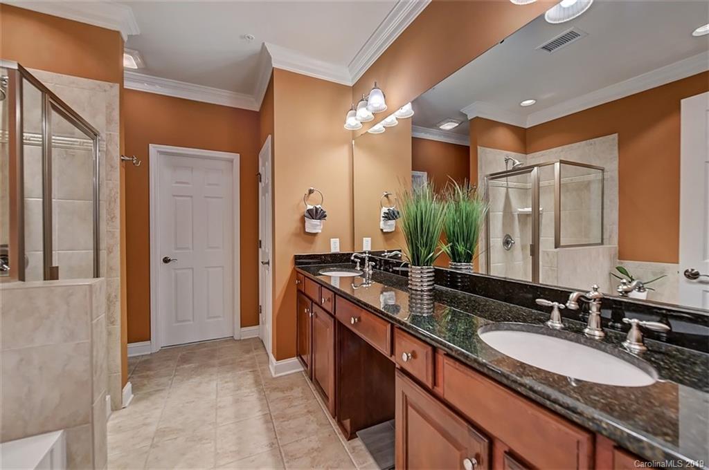 405 Halyard Lane Tega Cay, SC 29708 - Photo 26 of 48 a bathroom with a double vanity sink a mirror and a shower