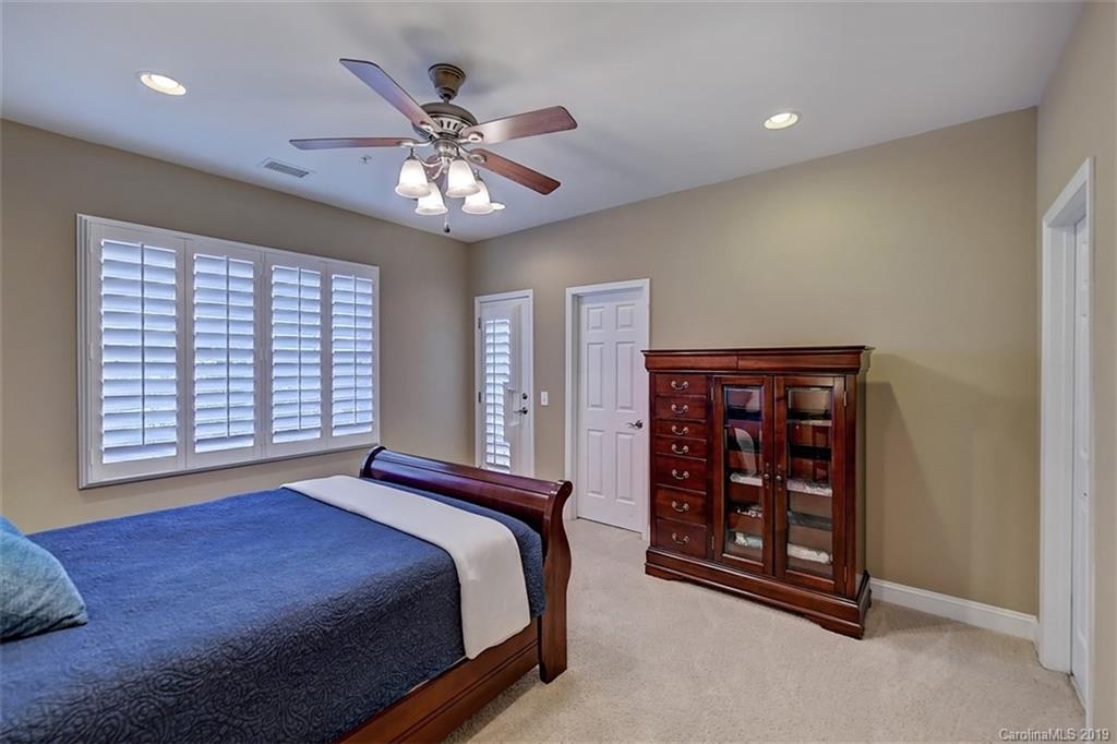 405 Halyard Lane Tega Cay, SC 29708 - Photo 37 of 48 a bedroom with a large bed and a chandelier