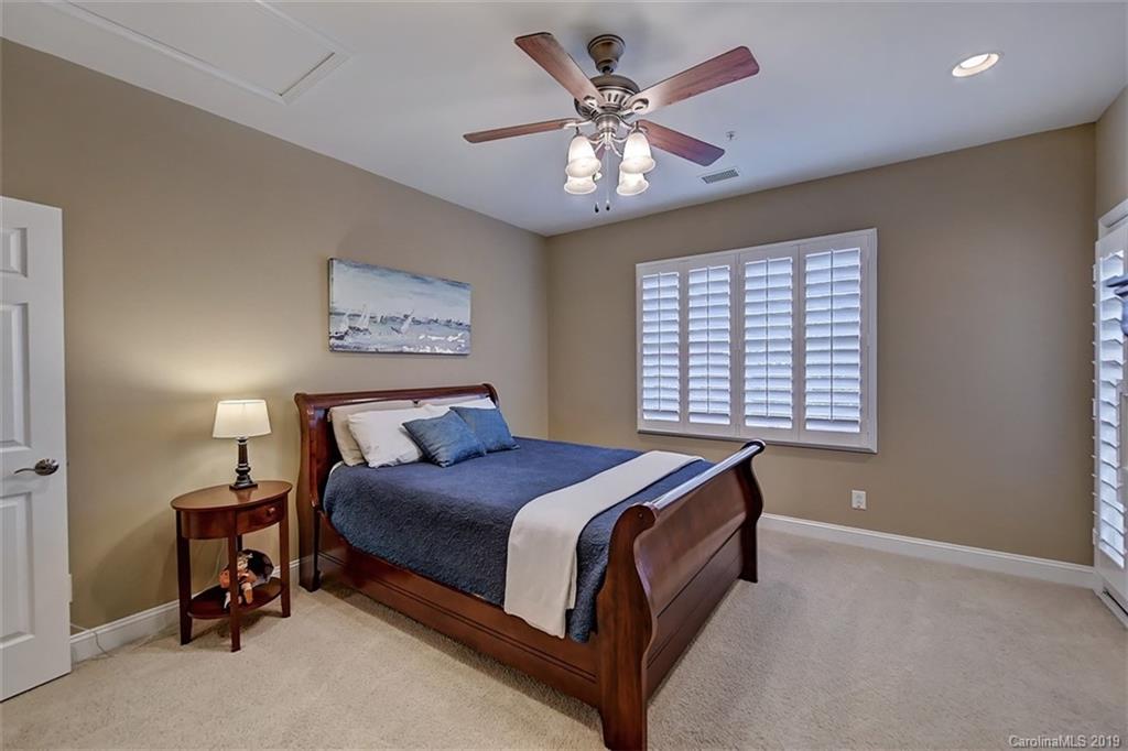 405 Halyard Lane Tega Cay, SC 29708 - Photo 38 of 48 a spacious bedroom with a bed and a chandelier