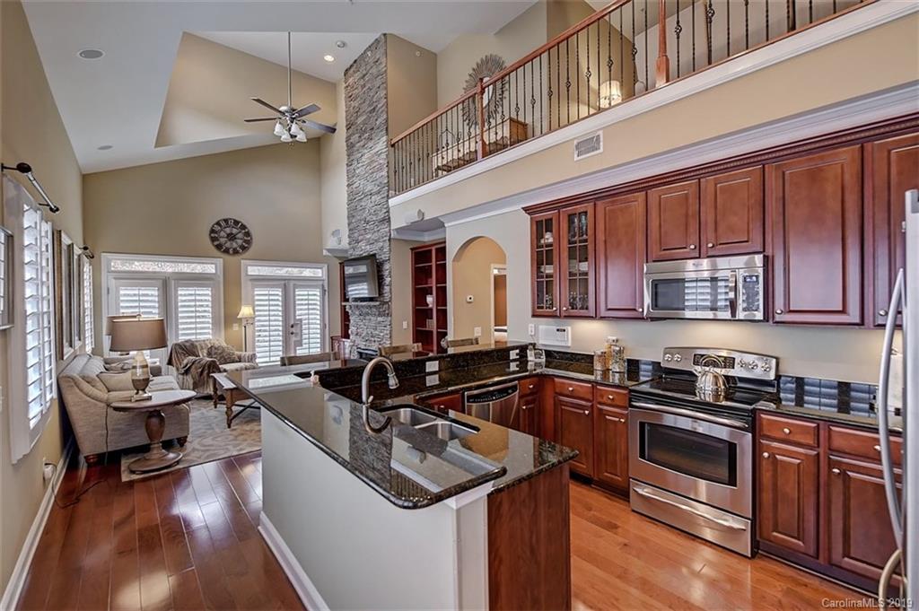 405 Halyard Lane Tega Cay, SC 29708 - Photo 7 of 48 a kitchen with granite countertop a sink stove and cabinets