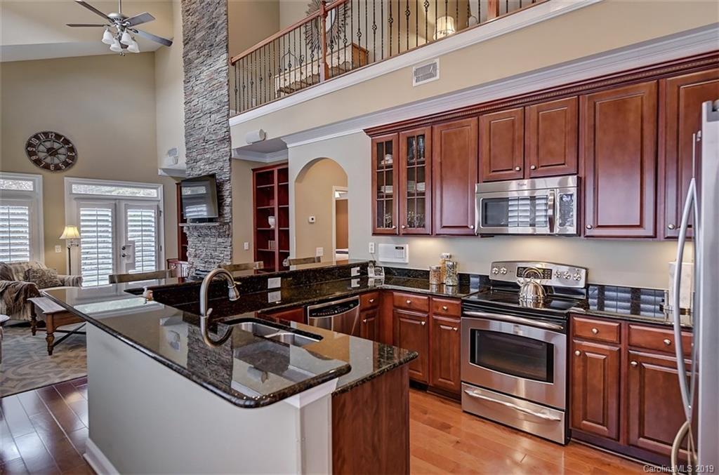 405 Halyard Lane Tega Cay, SC 29708 - Photo 8 of 48 a kitchen with stainless steel appliances granite countertop a sink and a stove