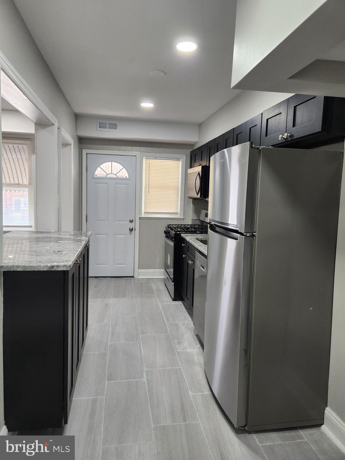 4113 Century Road Baltimore, MD 21206 - Photo 6 of 27 a kitchen with stainless steel appliances granite countertop a refrigerator and a sink