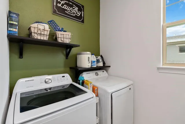 a view of a room that has a door and a window