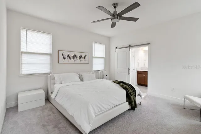 a bed room with a bed and a chair