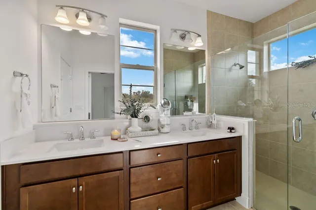 a bathroom with a shower sink and mirror