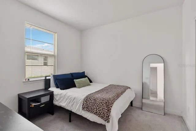 a bedroom with a bed and a dresser