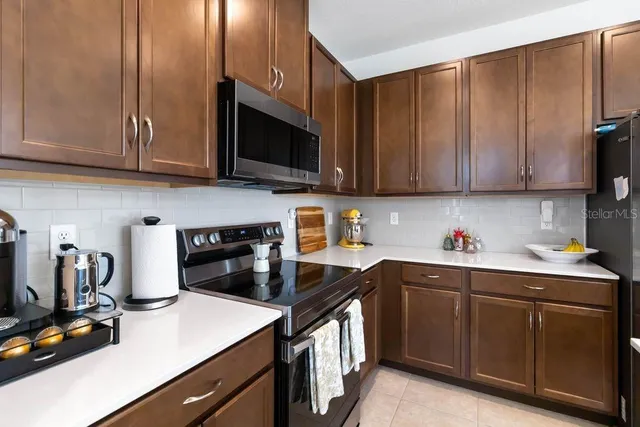 a kitchen with stainless steel appliances granite countertop a sink stove and microwave