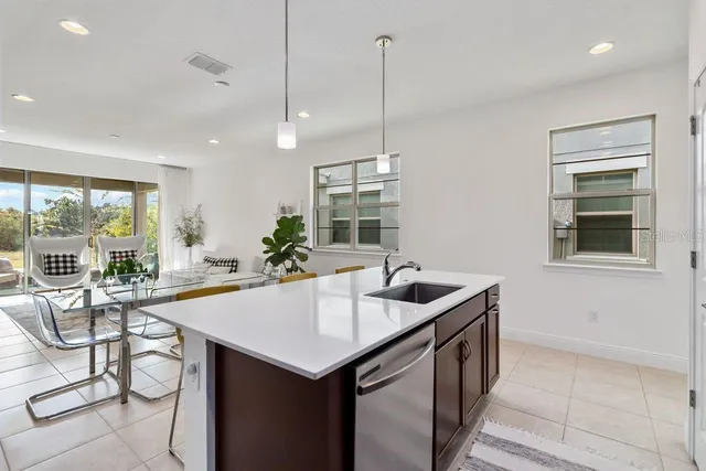 a kitchen with a stove a sink a counter space and dining table