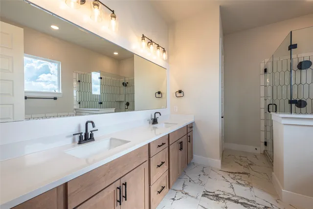 a bathroom with a glass shower door