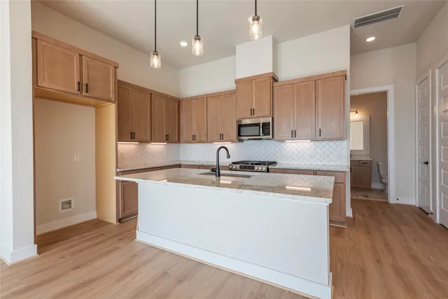 a kitchen with granite countertop a sink and a stove
