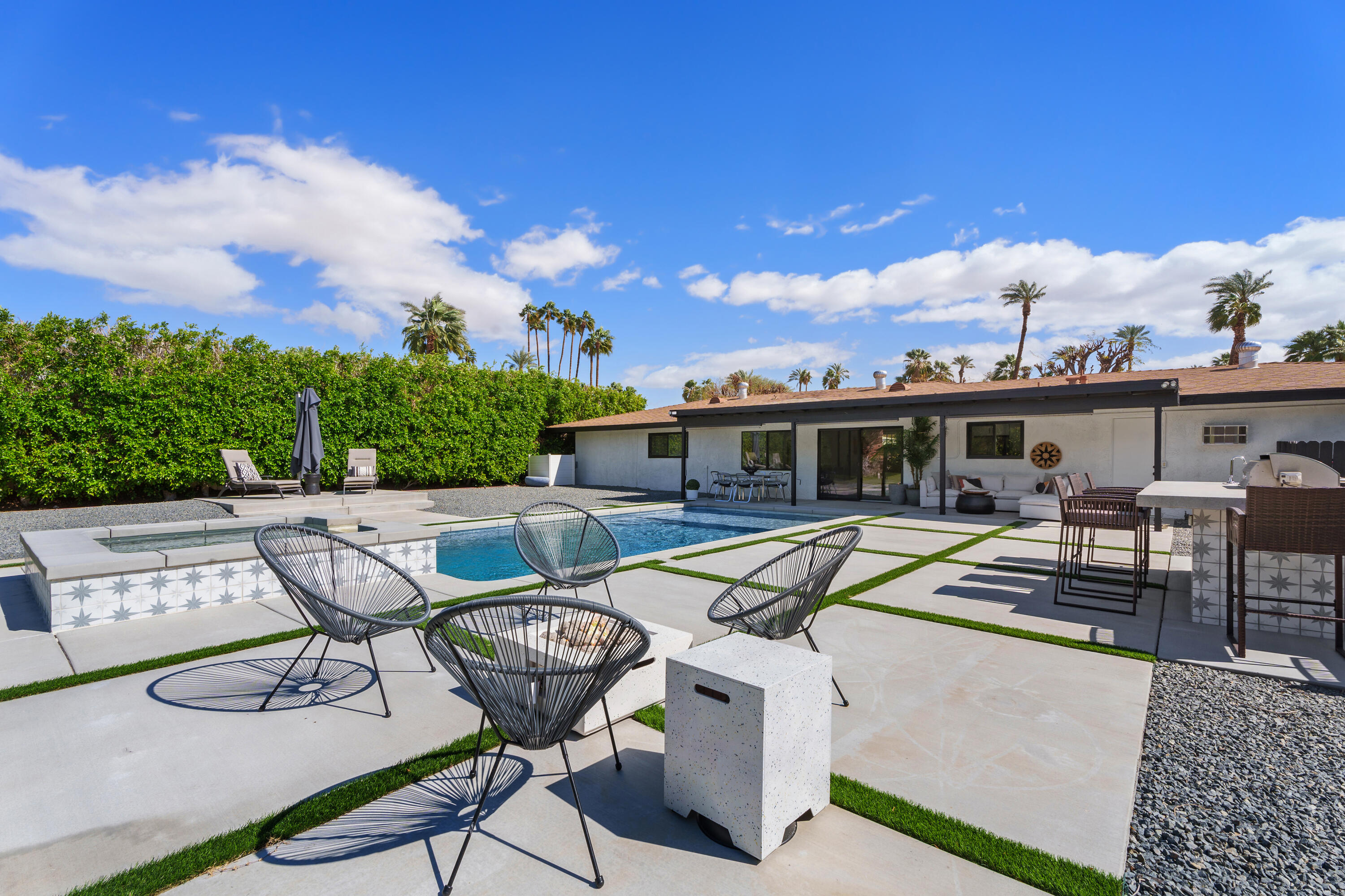 37081 Palmdale Road Rancho Mirage, CA 92270 - Photo 7 of 46 a view of a patio with couches table and chairs with wooden floor and fence