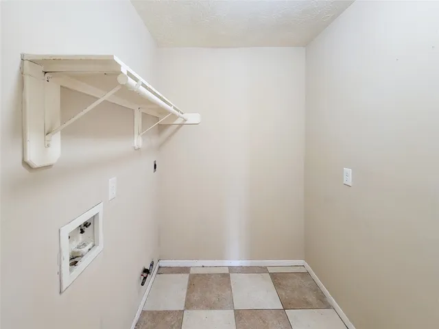 a view of walk in closet with white walls