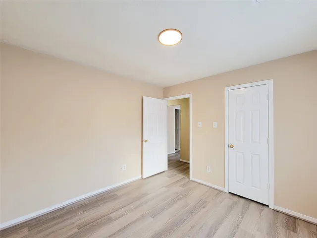 a view of an empty room and wooden floor