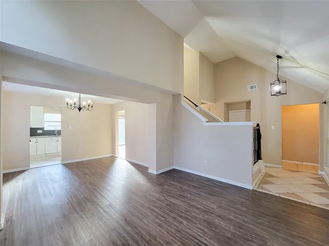 a view of a kitchen with wooden floor and a refrigerator