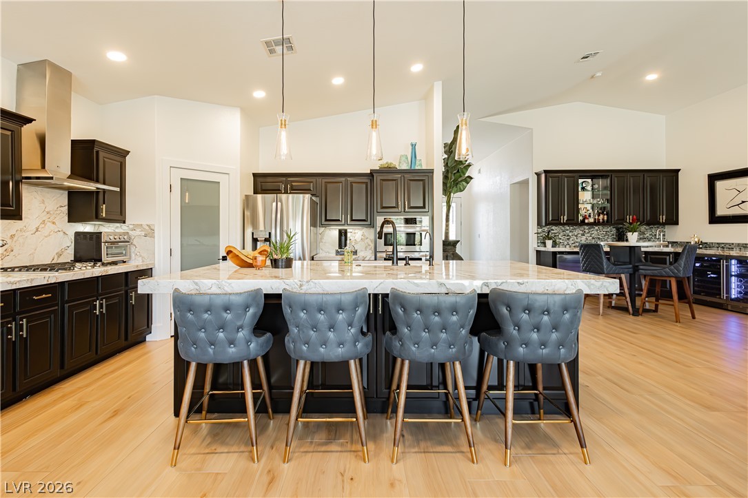 2256 Dogwood Ranch Avenue Henderson, NV 89052 - Photo 19 of 51 Culinary excellence awaits in this well-appointed kitchen, featuring a spacious island and gleaming wood flooring.