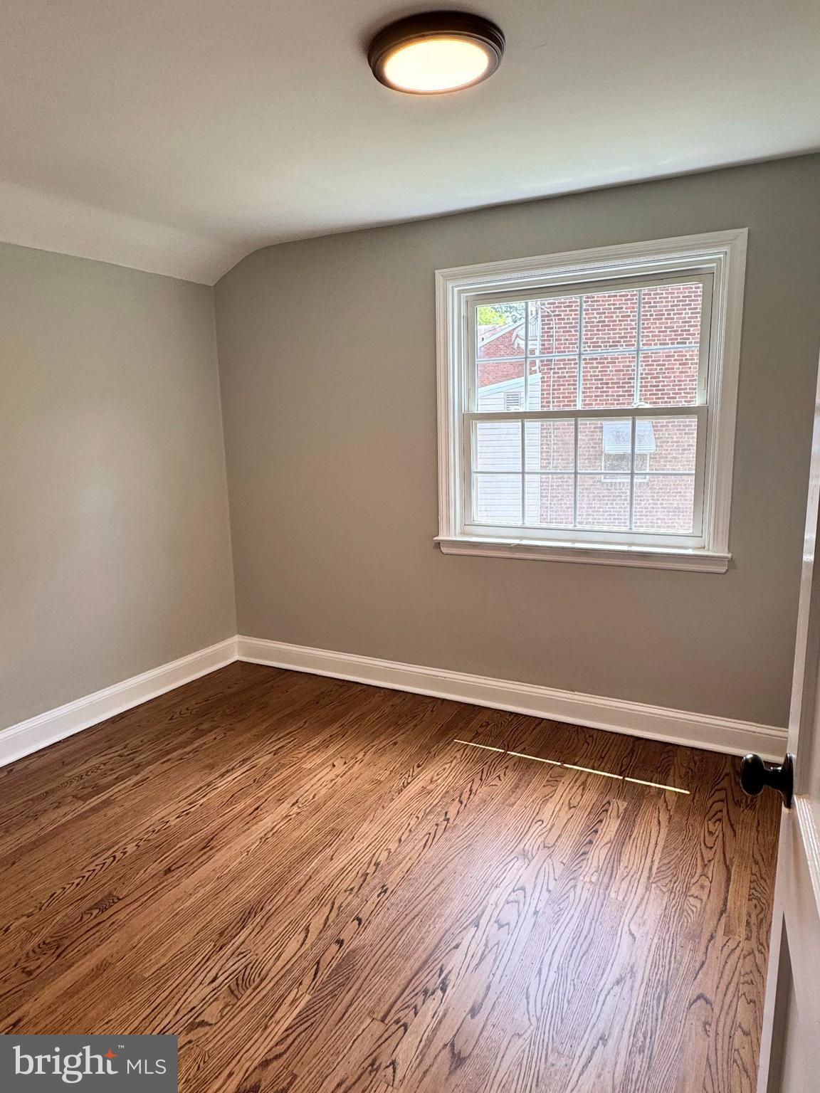 563 Rutherford Drive Springfield, PA 19064 - Photo 12 of 28 an empty room with wooden floor and windows