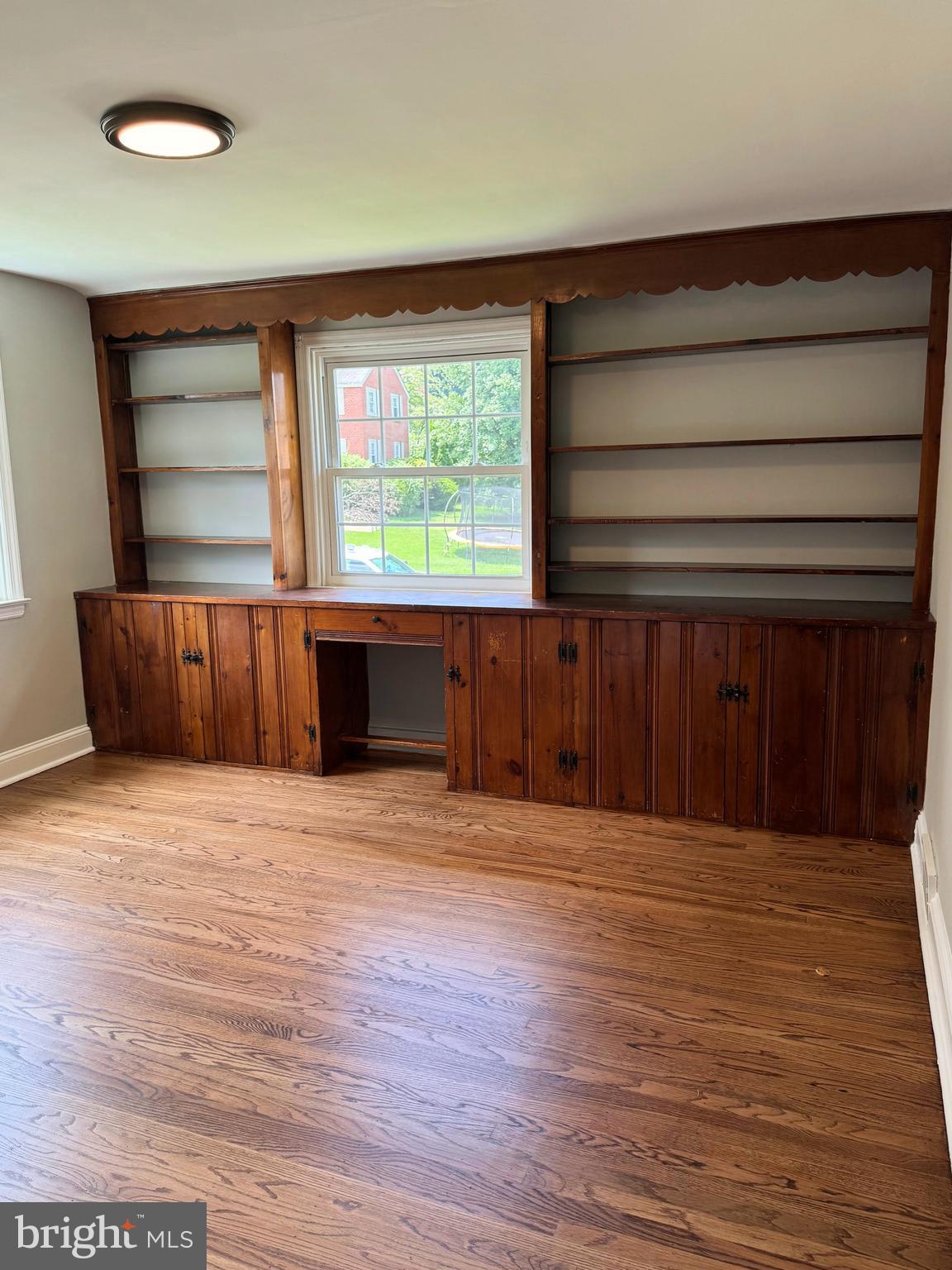 563 Rutherford Drive Springfield, PA 19064 - Photo 5 of 28 a view of an empty room with wooden floor and a window