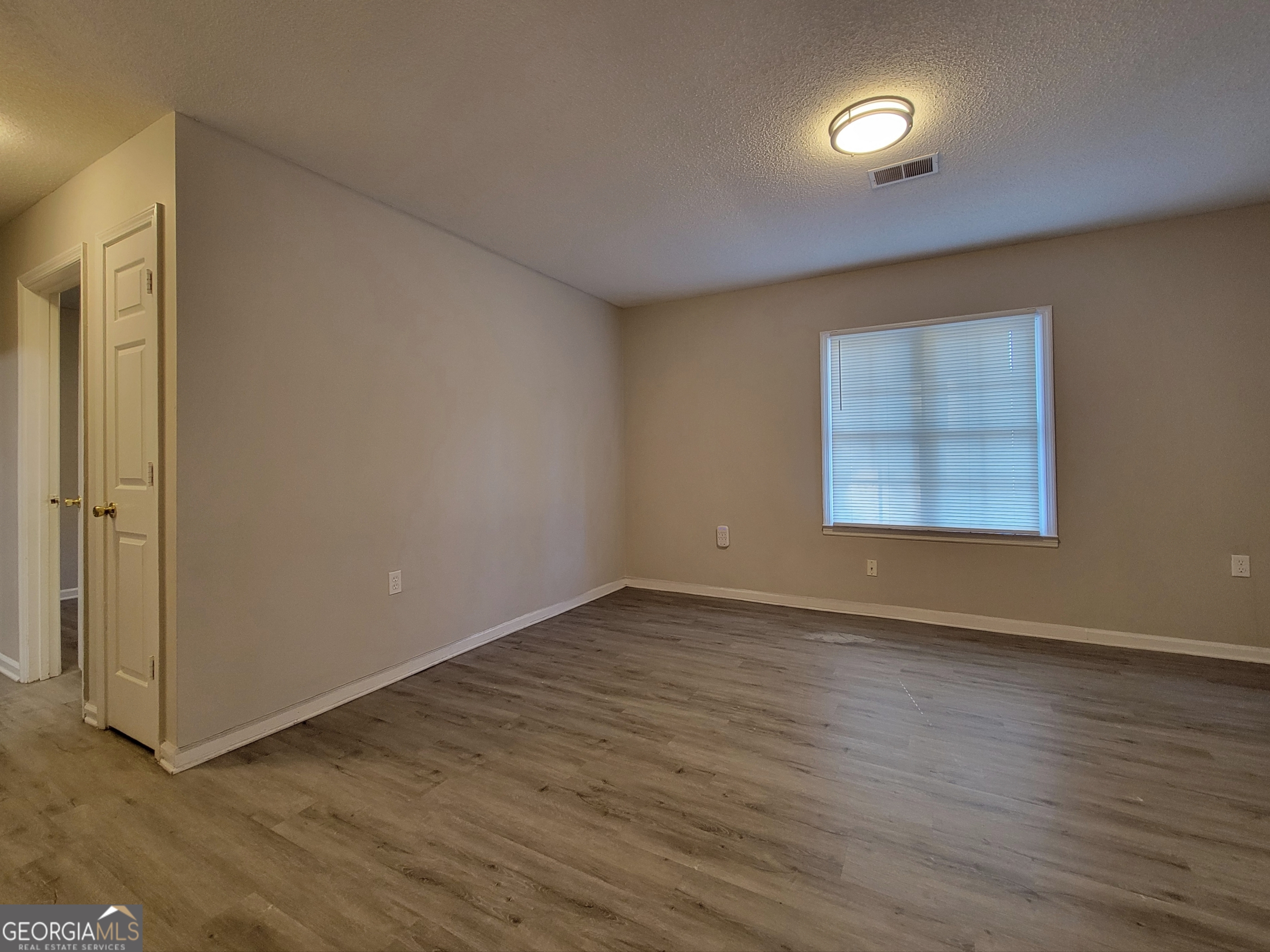 422 Highway 211 Street Northwest, Unit F Winder, GA 30680 - Photo 2 of 9 an empty room with wooden floor and windows