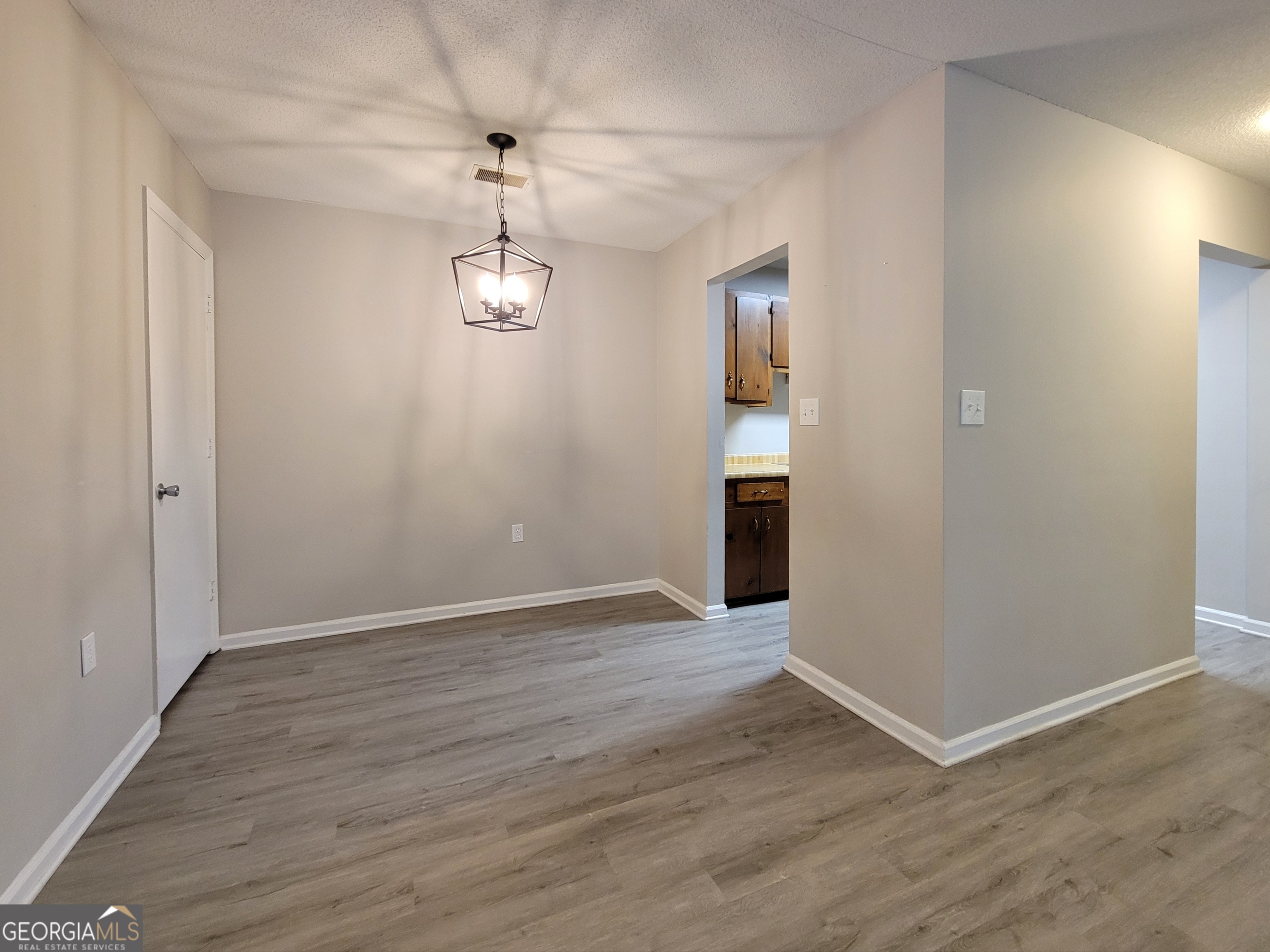 422 Highway 211 Street Northwest, Unit F Winder, GA 30680 - Photo 3 of 9 an empty room with wooden floor and windows