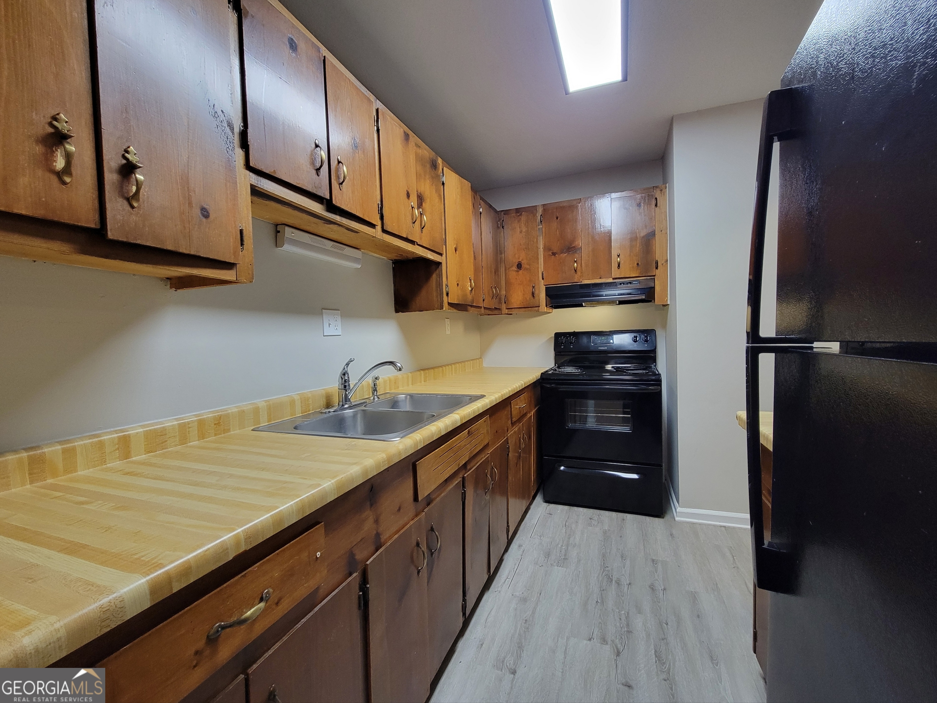 422 Highway 211 Street Northwest, Unit F Winder, GA 30680 - Photo 4 of 9 a kitchen with stainless steel appliances a refrigerator sink and cabinets