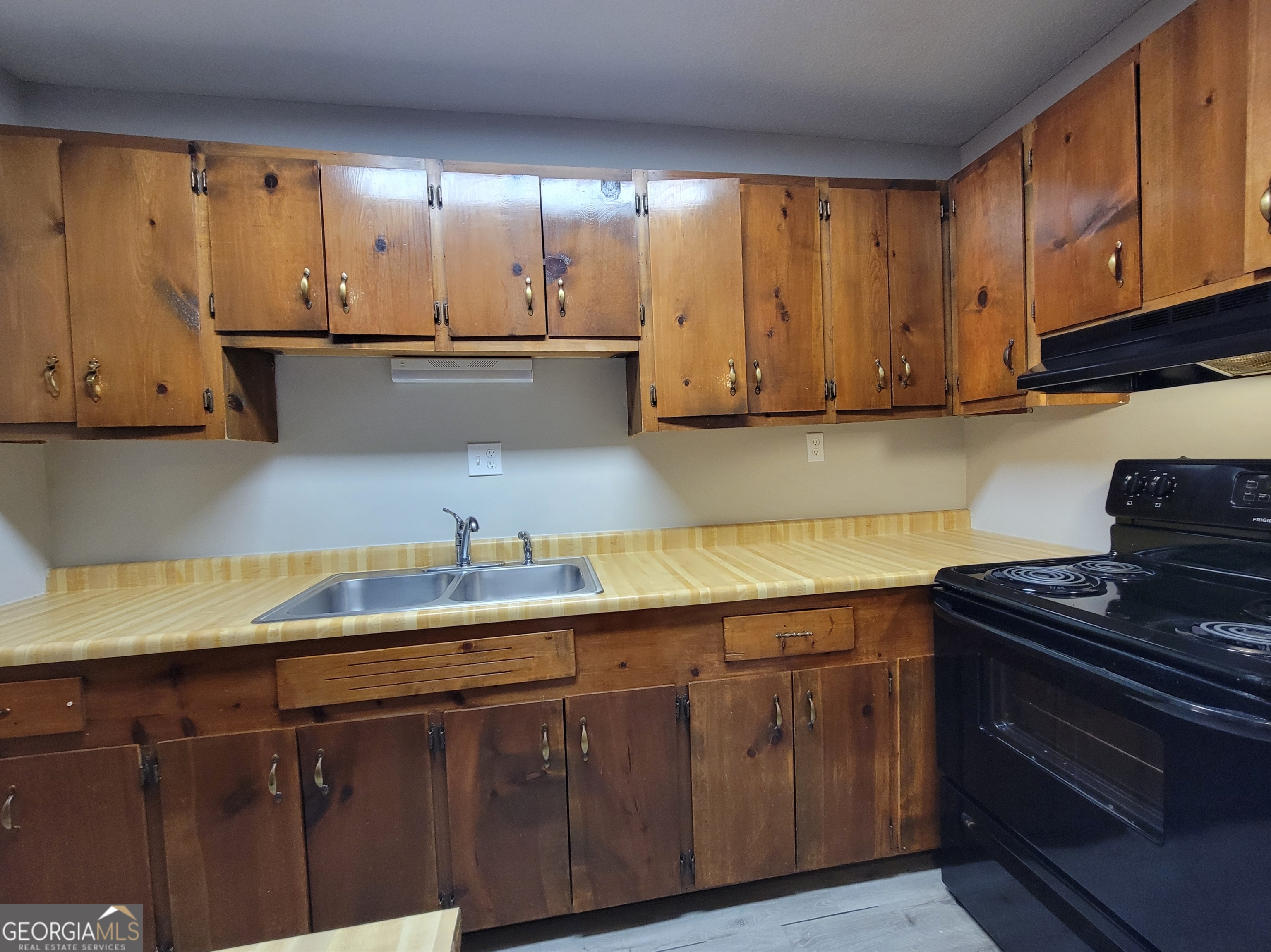 422 Highway 211 Street Northwest, Unit F Winder, GA 30680 - Photo 5 of 9 a kitchen with granite countertop a sink a stove and cabinets