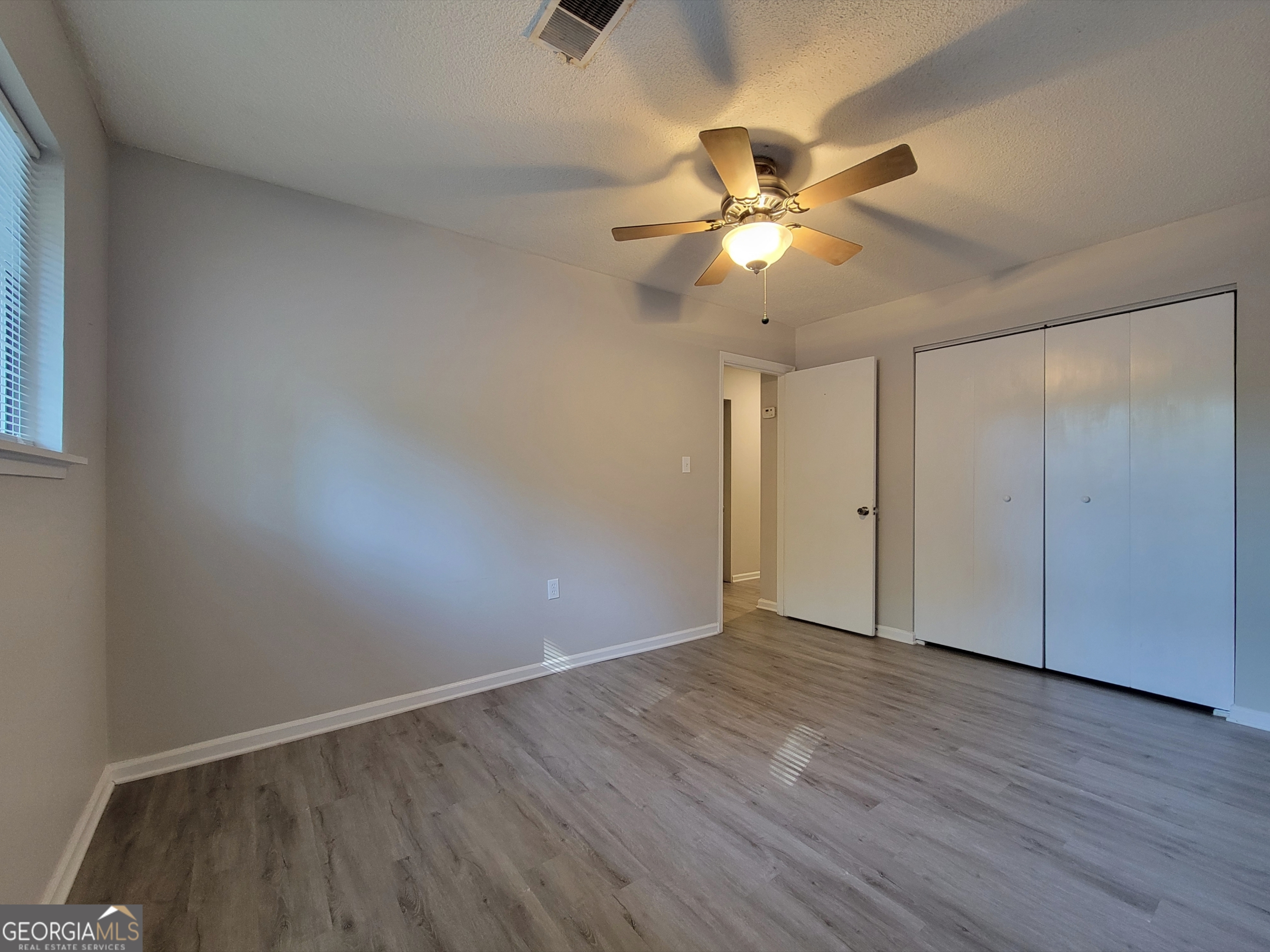 422 Highway 211 Street Northwest, Unit F Winder, GA 30680 - Photo 6 of 9 a view of an empty room with wooden floor