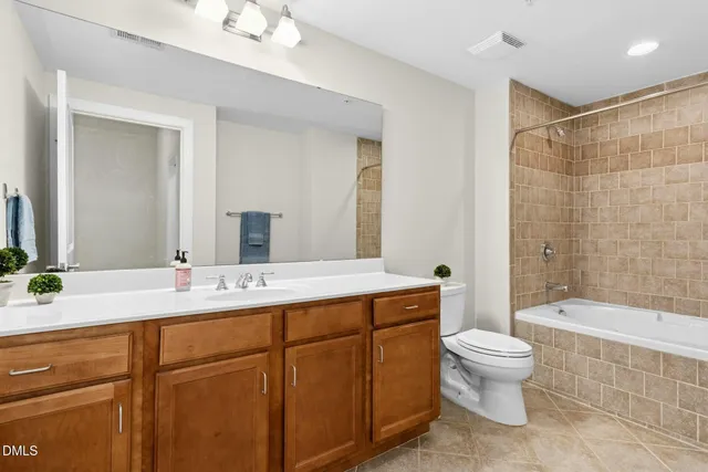 a bathroom with a sink a toilet and bathtub