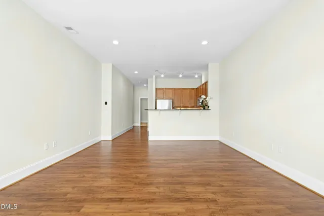 a view of a kitchen with a sink and wooden floor