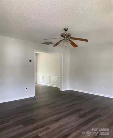 a view of a room with wooden floor and cabinet