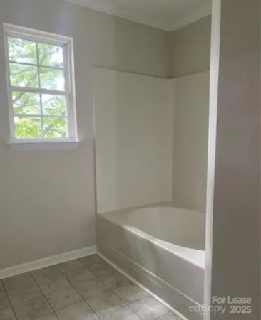 a white bath tub sitting next to a window