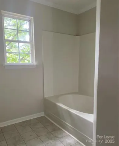 a white bath tub sitting next to a window