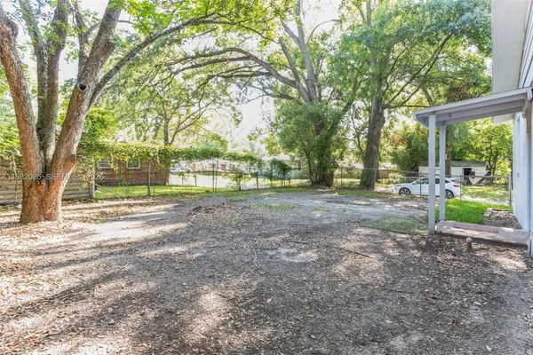 a view of a yard with a tree