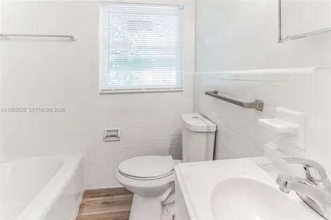 a bathroom with a sink a toilet and bathtub
