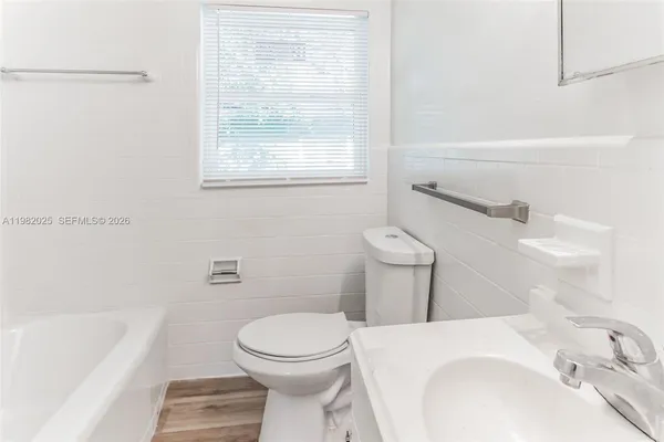 a bathroom with a sink a toilet and bathtub