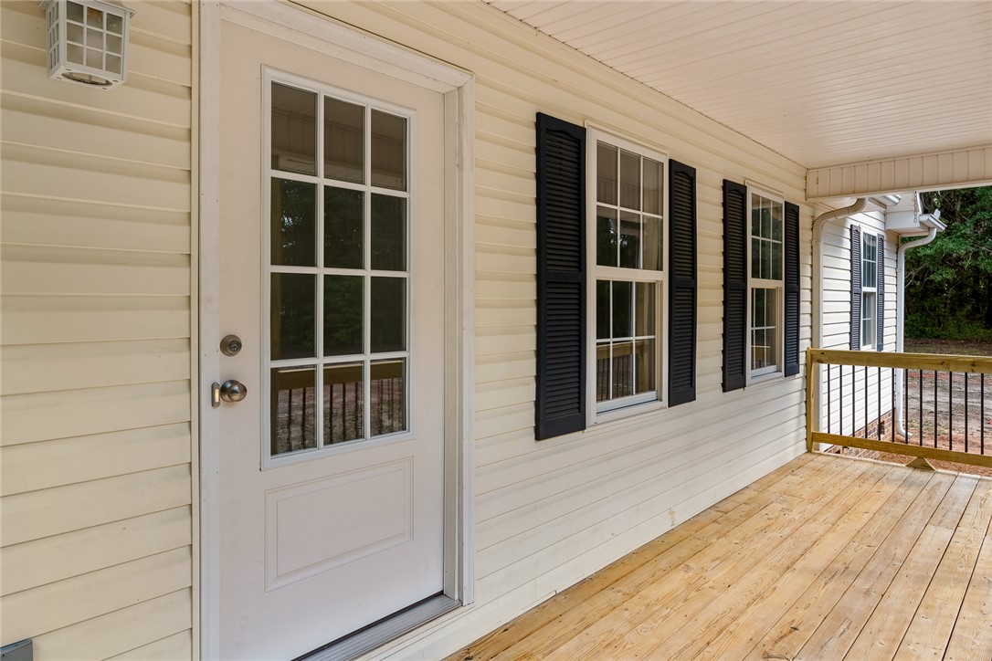 131 Lockaby Road Pelzer, SC 29669 - Photo 12 of 50 This inviting porch welcomes you to a charming home, offering a perfect spot for relaxation.