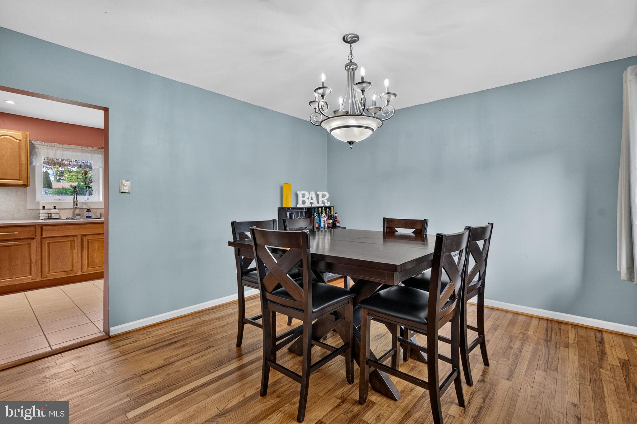 12 Woodbridge Road Gibbsboro, NJ 08026 - Photo 22 of 45 a view of a dining room with furniture a chandelier and wooden floor