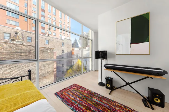 a living room with a couch a rug and a large window